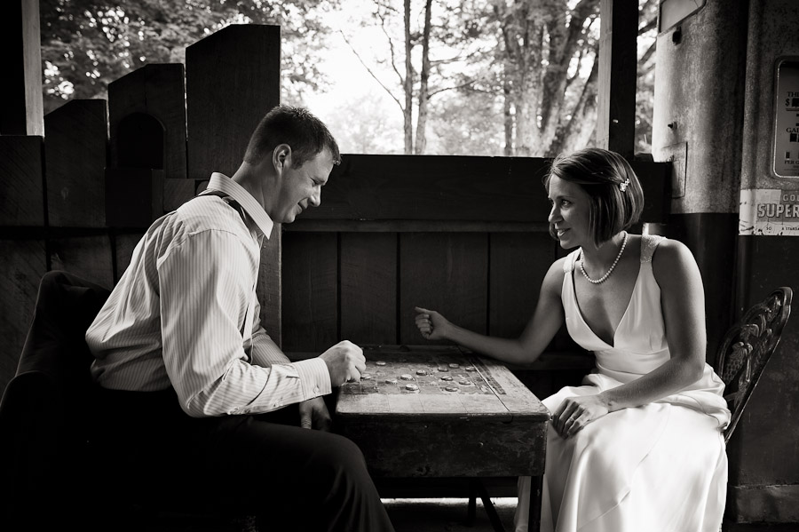 story-inn-wedding-brooke-hank-6 bride and groom playing checkers at story inn in brown county indiana