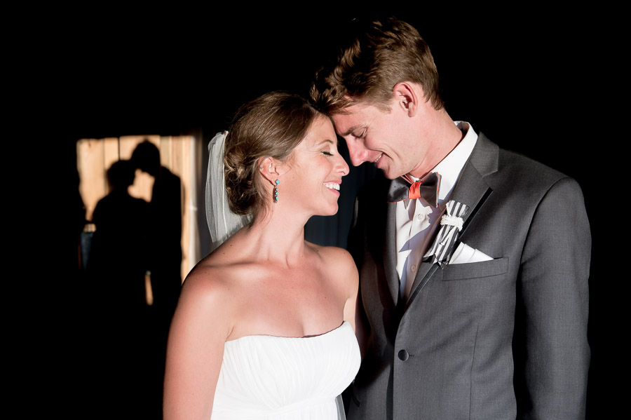 creative and romantic bride and groom photo in barn with shadows