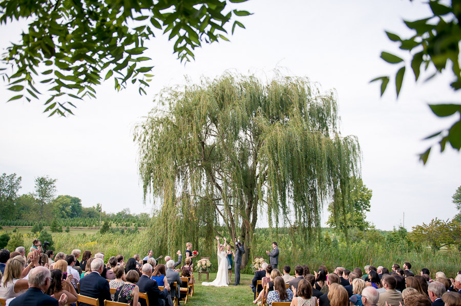 Dulls-Tree-Farm-Wedding-Photography-Indiana-Anna-Dan-11 happy couple celebrating during wedding ceremony at Dull's Tree Farm