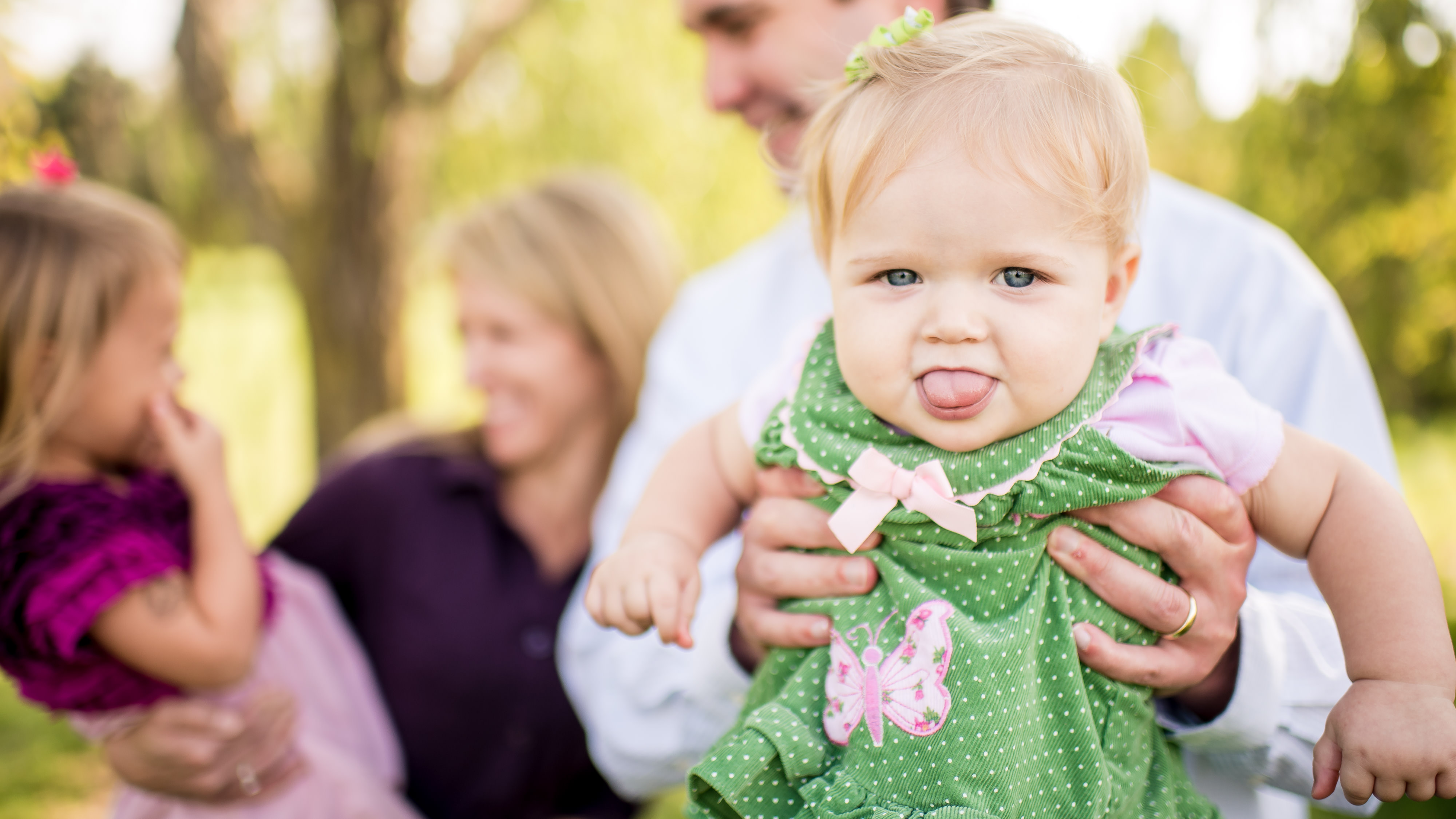 Funny baby tongue at family photoshoot