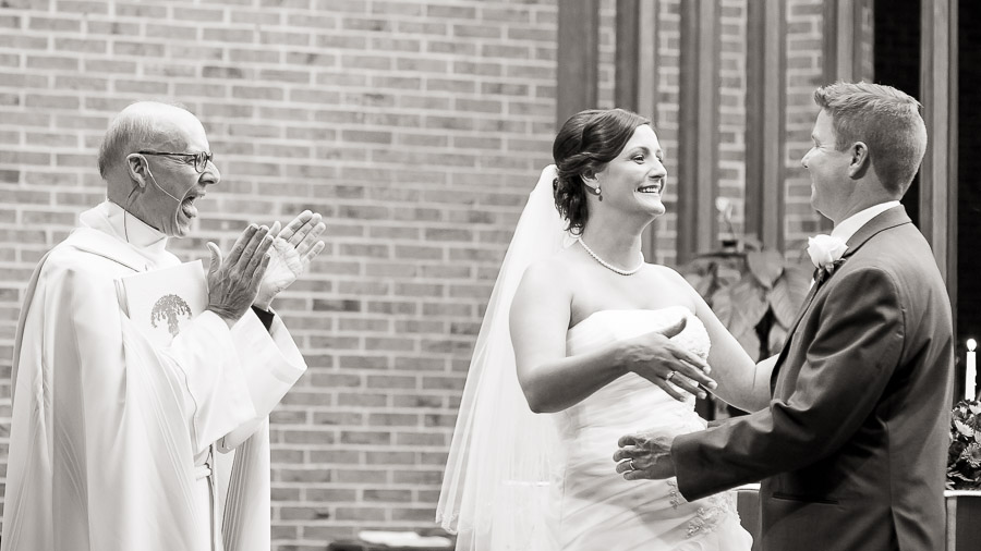 Indianapolis-Marriott-North-Indiana-Wedding-Ashleigh-Jake-02 Very happy priest and newly married couple at Christ the King church