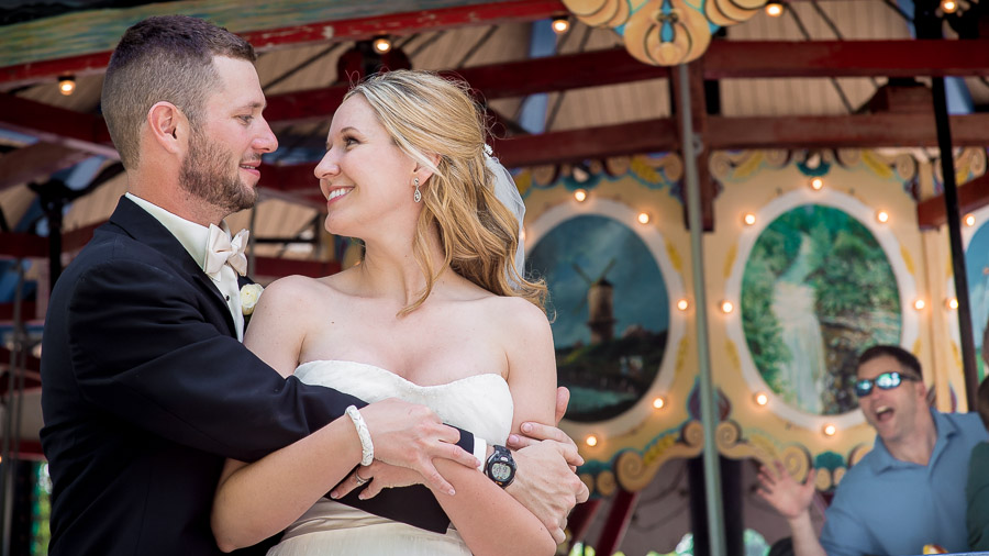 Bloomington-Indianapolis-Wedding-Photographers-2013-Favorite-Photos-of-the-Year-55 funny photobomb of wedding couple by dude on carousel at Indiana wedding