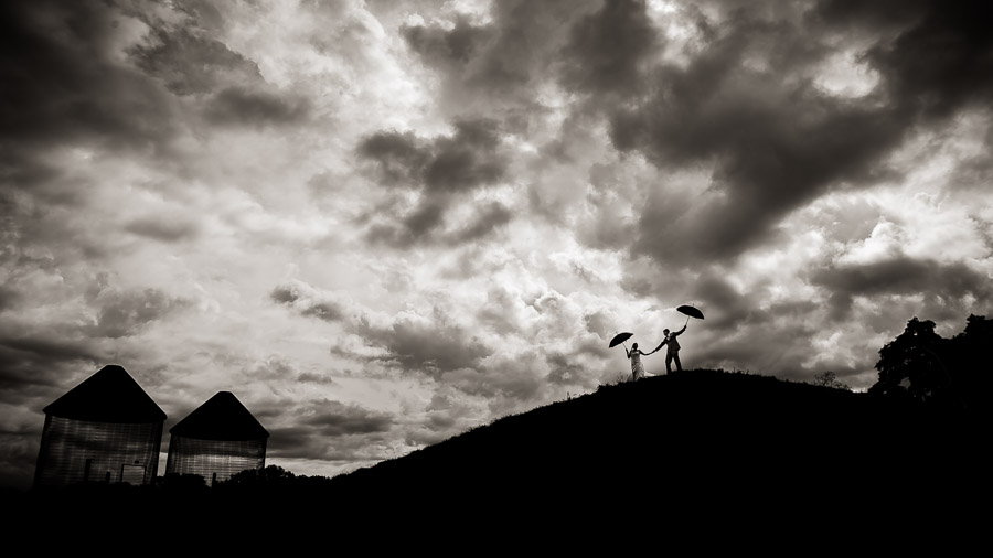 Bloomington-Indianapolis-Wedding-Photographers-2013-Favorite-Photos-of-the-Year-77 Dramatic, cloudy, windy, wedding day portrait with umbrellas by TALL + small Photography